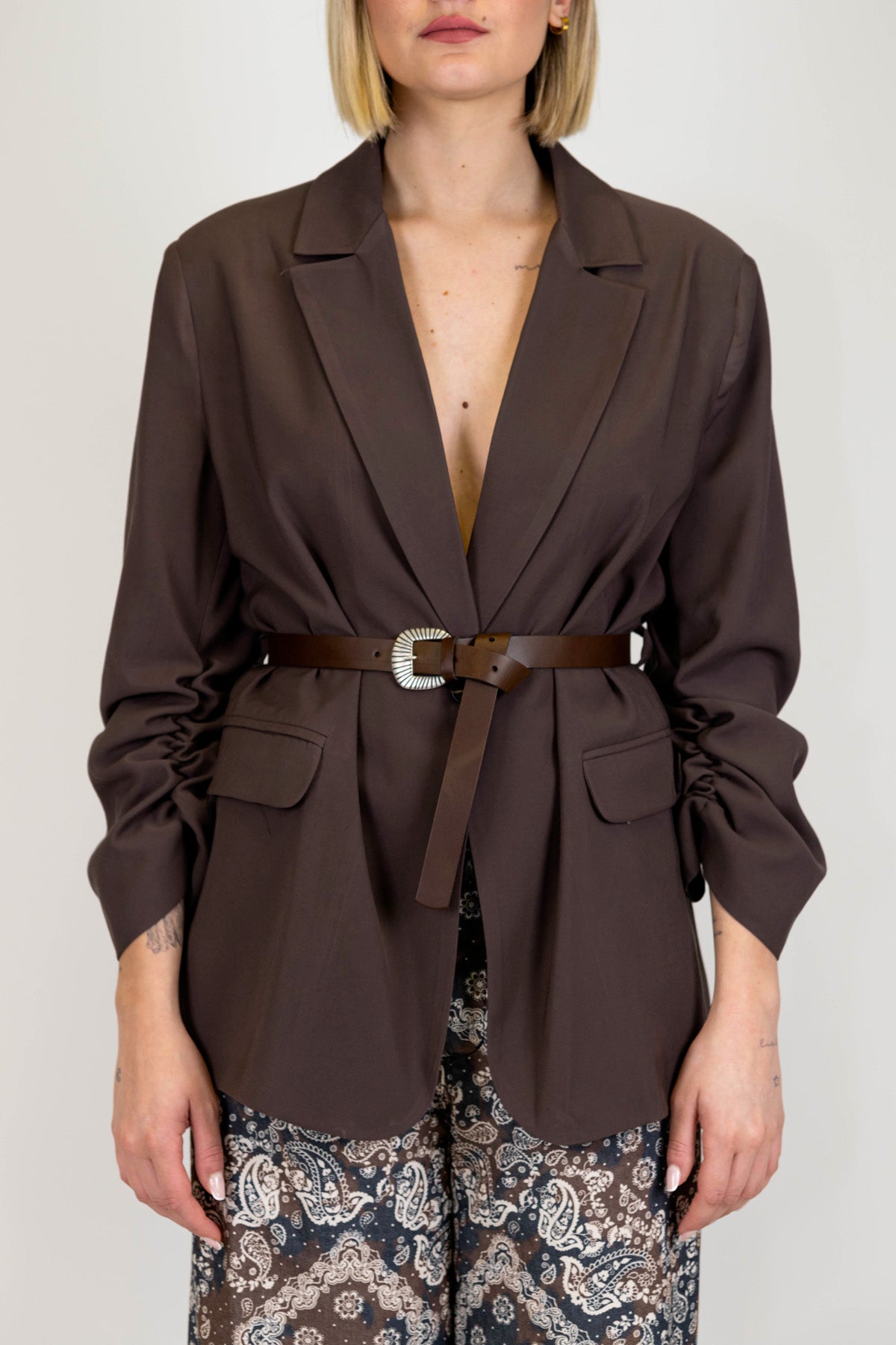 Tensione in - Giacca priva di bottone con cintura e manica arricciata